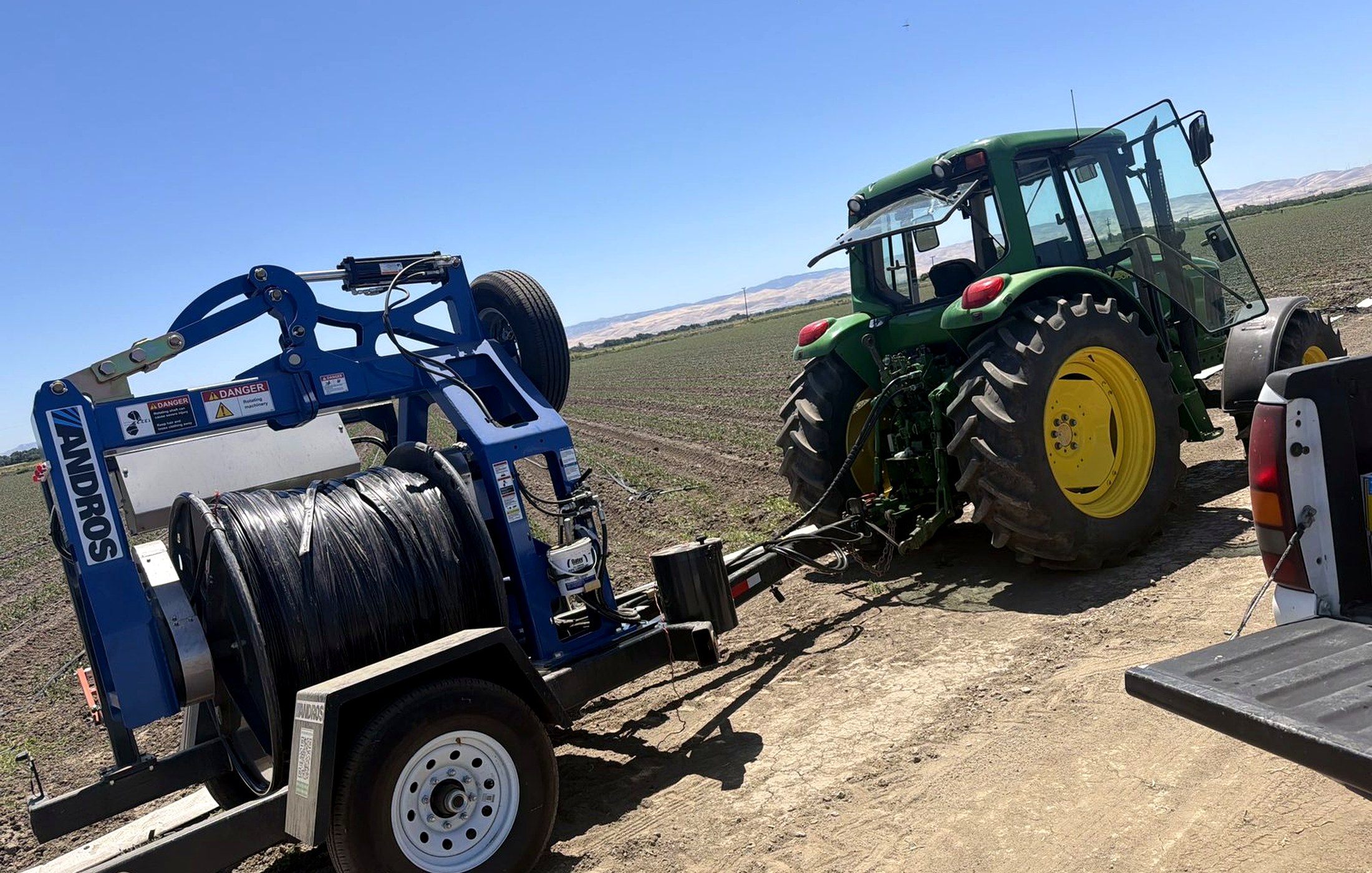 Tractor and agricultural recycling equipment in a California field